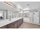 Bright bathroom featuring a double sink vanity with a large mirror, separate tub and shower, and neutral tiling at 4628 W Hasan Dr, Laveen, AZ 85339