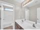 Bathroom featuring a double sink vanity with a large mirror and a shower/tub combo at 4628 W Hasan Dr, Laveen, AZ 85339