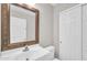 Bathroom featuring a single sink vanity, a framed mirror, a toilet and a closet at 4628 W Hasan Dr, Laveen, AZ 85339