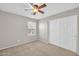 Bedroom with ceiling fan, neutral carpet, and a window that provides natural light at 4628 W Hasan Dr, Laveen, AZ 85339