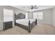 Bedroom with plush carpet and featuring a dark wood bed frame and ceiling fan at 4628 W Hasan Dr, Laveen, AZ 85339