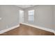 Inviting bedroom featuring wood flooring, neutral walls, and a bright window at 4628 W Hasan Dr, Laveen, AZ 85339