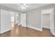 Bright bedroom with wood floors, closet, and doorway to an additional room at 4628 W Hasan Dr, Laveen, AZ 85339