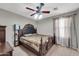 Bedroom with a large wooden bed frame and ceiling fan at 4628 W Hasan Dr, Laveen, AZ 85339