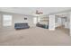 Large bonus room provides ample space, carpet flooring, and lots of natural light from the windows at 4628 W Hasan Dr, Laveen, AZ 85339