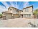 Two-story house with a three-car garage and desert landscaping at 4628 W Hasan Dr, Laveen, AZ 85339