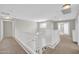 Upstairs hallway with white railing and natural light showcasing spacious layout at 4628 W Hasan Dr, Laveen, AZ 85339