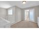 Bright hallway with neutral colors, carpet flooring, white trim, and a view of another room at 4628 W Hasan Dr, Laveen, AZ 85339