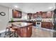 L-shaped kitchen with dark wood cabinets and granite countertops at 4628 W Hasan Dr, Laveen, AZ 85339