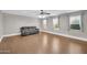 Bright living room featuring wood flooring, ceiling fan and large windows at 4628 W Hasan Dr, Laveen, AZ 85339