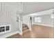 Open living area featuring hardwood floors and a staircase with white banisters at 4628 W Hasan Dr, Laveen, AZ 85339