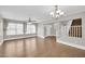 Spacious living room with hardwood floors, a ceiling fan, and large windows at 4628 W Hasan Dr, Laveen, AZ 85339