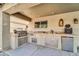 Outdoor kitchen featuring a grill, sink, and ample cabinet space at 4628 W Hasan Dr, Laveen, AZ 85339