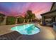 Evening view of kidney-shaped pool and patio at 4628 W Hasan Dr, Laveen, AZ 85339