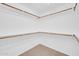 Spacious walk-in closet with neutral carpet and multiple levels of shelving/clothing bars, offering ample storage at 4628 W Hasan Dr, Laveen, AZ 85339
