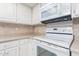 Kitchen with white cabinets and built-in microwave at 5102 N 31St Pl # 422, Phoenix, AZ 85016