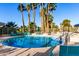Community pool with lounge chairs and palm trees at 5102 N 31St Pl # 422, Phoenix, AZ 85016