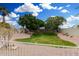 Landscaped backyard with grassy area and trees at 5830 E Mckellips Rd # 100, Mesa, AZ 85215