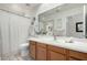 Clean bathroom with wood cabinets and a large mirror at 5830 E Mckellips Rd # 100, Mesa, AZ 85215