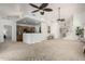 Open living room with high ceilings, ceiling fans, and carpet flooring at 5830 E Mckellips Rd # 100, Mesa, AZ 85215