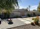 Landscaped backyard with tiled patio, water feature, and seating at 6307 E Gelding Dr, Scottsdale, AZ 85254