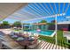 Outdoor dining area under a pergola, adjacent to the pool at 8330 E Sells Dr, Scottsdale, AZ 85251