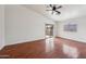 Living room with hardwood floors, sliding glass door, and ceiling fan at 8933 W Catalina Dr, Phoenix, AZ 85037