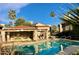 Community pool with ample lounge chairs and shade structures at 9115 E Purdue Ave # 211, Scottsdale, AZ 85258