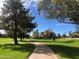 Paved walking path winds through lush green landscaping at 9115 E Purdue Ave # 211, Scottsdale, AZ 85258