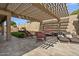 Relaxing backyard patio with pergola, seating area, and artificial turf at 9348 E Grandview St, Mesa, AZ 85207