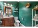 Powder room with dark green walls and wood vanity at 9348 E Grandview St, Mesa, AZ 85207