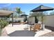 Private backyard oasis with covered patio, seating area, and lush landscaping at 9573 E Dreyfus Pl, Scottsdale, AZ 85260