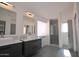 Modern bathroom with double sinks, walk-in shower, and ample storage at 9573 E Dreyfus Pl, Scottsdale, AZ 85260