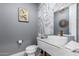 Elegant powder room with marble tile and modern vanity at 12451 E Troon Vista Dr, Scottsdale, AZ 85255
