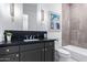 Modern bathroom with dark vanity and large format tile at 12451 E Troon Vista Dr, Scottsdale, AZ 85255