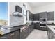 Sleek kitchen with dark cabinetry, gas range, and ample counter space at 12451 E Troon Vista Dr, Scottsdale, AZ 85255