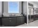 Butler's pantry with dark cabinetry and built-in coffee bar at 12451 E Troon Vista Dr, Scottsdale, AZ 85255