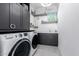 Bright laundry room with stacked washer and dryer at 12451 E Troon Vista Dr, Scottsdale, AZ 85255