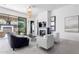 Relaxing living area features comfortable seating, fireplace, and backyard access at 12451 E Troon Vista Dr, Scottsdale, AZ 85255