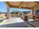 Covered patio with seating area and outdoor fireplace at 12451 E Troon Vista Dr, Scottsdale, AZ 85255