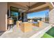 Covered patio with seating area and built-in grill at 12451 E Troon Vista Dr, Scottsdale, AZ 85255