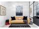 Stylish sitting area with mustard sofa and abstract art at 12451 E Troon Vista Dr, Scottsdale, AZ 85255