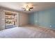 Bright bedroom with ceiling fan, carpet, and sliding glass door to patio at 14637 N Olympic Way, Fountain Hills, AZ 85268