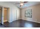 Bedroom with ceiling fan, dark wood floors and access to bathroom at 14637 N Olympic Way, Fountain Hills, AZ 85268