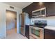 Modern kitchen with stainless steel appliances and dark wood cabinets at 14637 N Olympic Way, Fountain Hills, AZ 85268