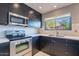 Modern kitchen with stainless steel appliances and dark wood cabinets at 14637 N Olympic Way, Fountain Hills, AZ 85268