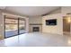Bright living room featuring a fireplace and sliding glass doors to a patio at 14637 N Olympic Way, Fountain Hills, AZ 85268