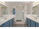 Bathroom boasts dual sinks, a shower, and blue vanity at 15225 N 100Th St # 1208, Scottsdale, AZ 85260