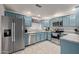 Modern kitchen with light blue cabinets and stainless steel appliances at 15225 N 100Th St # 1208, Scottsdale, AZ 85260