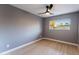 Bright bedroom with wood-look floors and a ceiling fan at 1743 W Butler Dr, Phoenix, AZ 85021